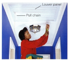 6. Attach the louver panel to the ceiling with screws into the joist and drywall anchors into the drywall. Louvers are drawn upward when fan is turned on and weighted to shut tightly when the fan is off.