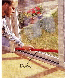 Bottom track. Supplement your existing lock by laying a cut-to-fit dowel in the lower door track.